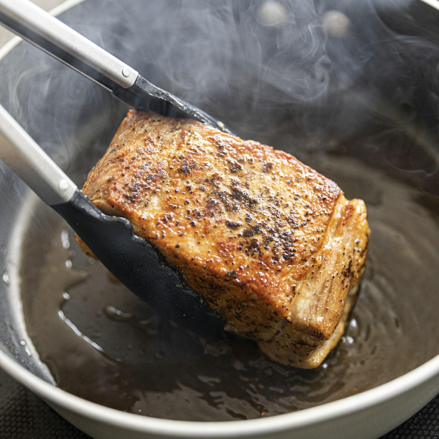 People working together in a contemporary kitchen, exchanging recipes and cooking skills